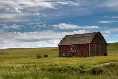 Red barn with clouds behind