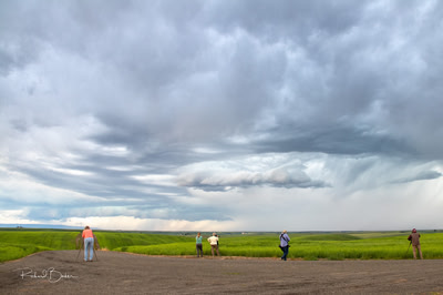 Photographers lining up to take pictures of storm clouds