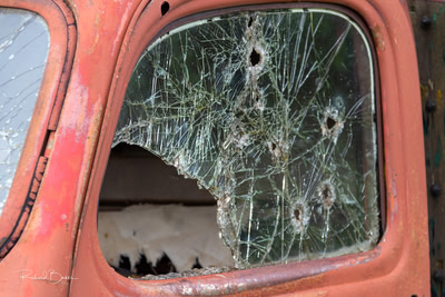 Truck window with bullet holes